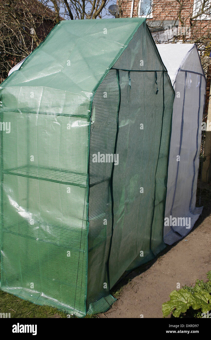 Temporary plastic greenhouses in urban garden Stock Photo