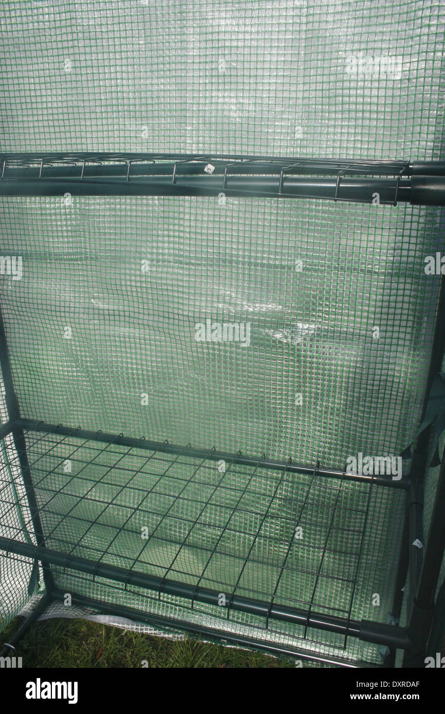plastic coated wire shelving in plastic greenhouse Stock Photo Alamy