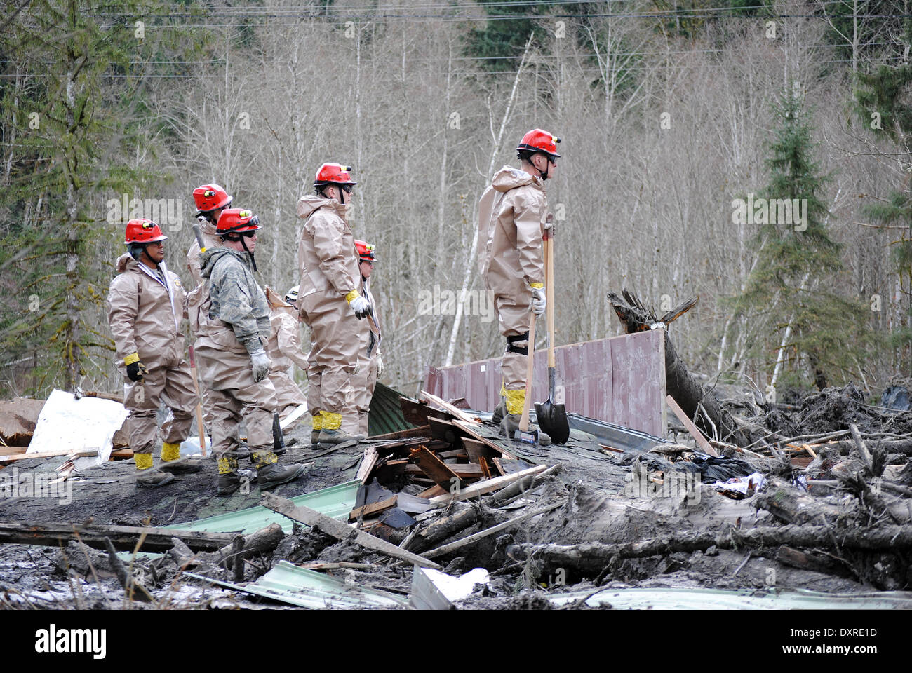 Rescue workers continue efforts to locate victims of a massive landslide that killed at least 28 people and destroyed a small riverside village in northwestern Washington state March 26, 2014 in Oso, Washington. Stock Photo