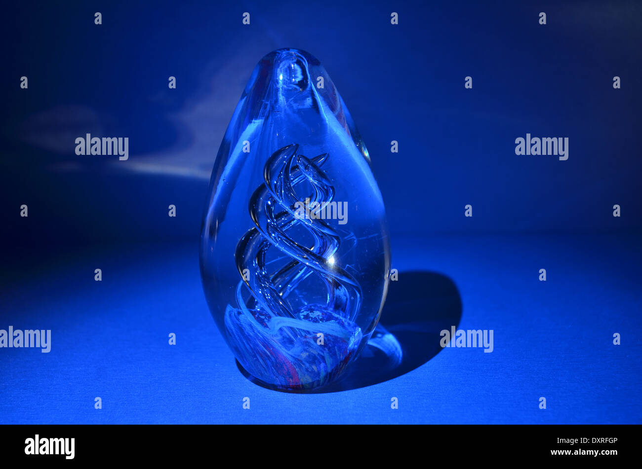 Glass ornament lit by blue light Stock Photo