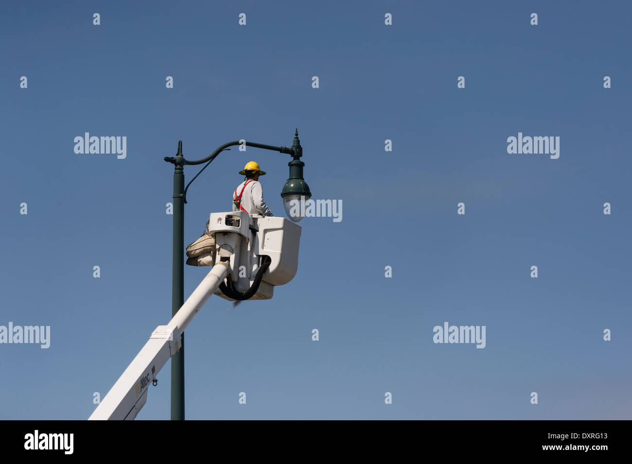Man in Aerial Bucket Truck changing light bulb in Leesburg, Florida USA Stock Photo