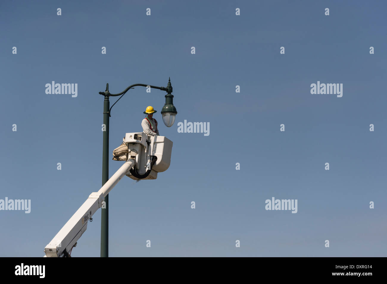 Man in Aerial Bucket Truck changing light bulb in Leesburg, Florida USA Stock Photo