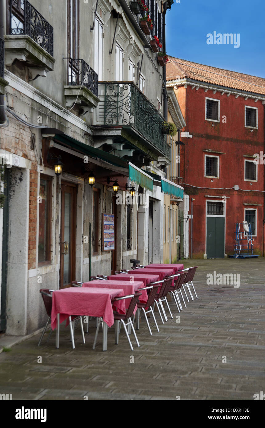 Classic Restaurant Tables and Chairs in Venice with red table cover Stock Photo
