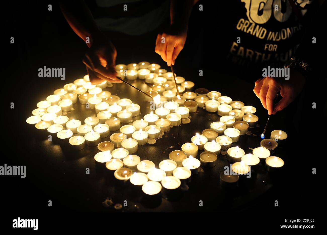 Jakarta, Indonesia. 29th Mar, 2014. People light candles during the