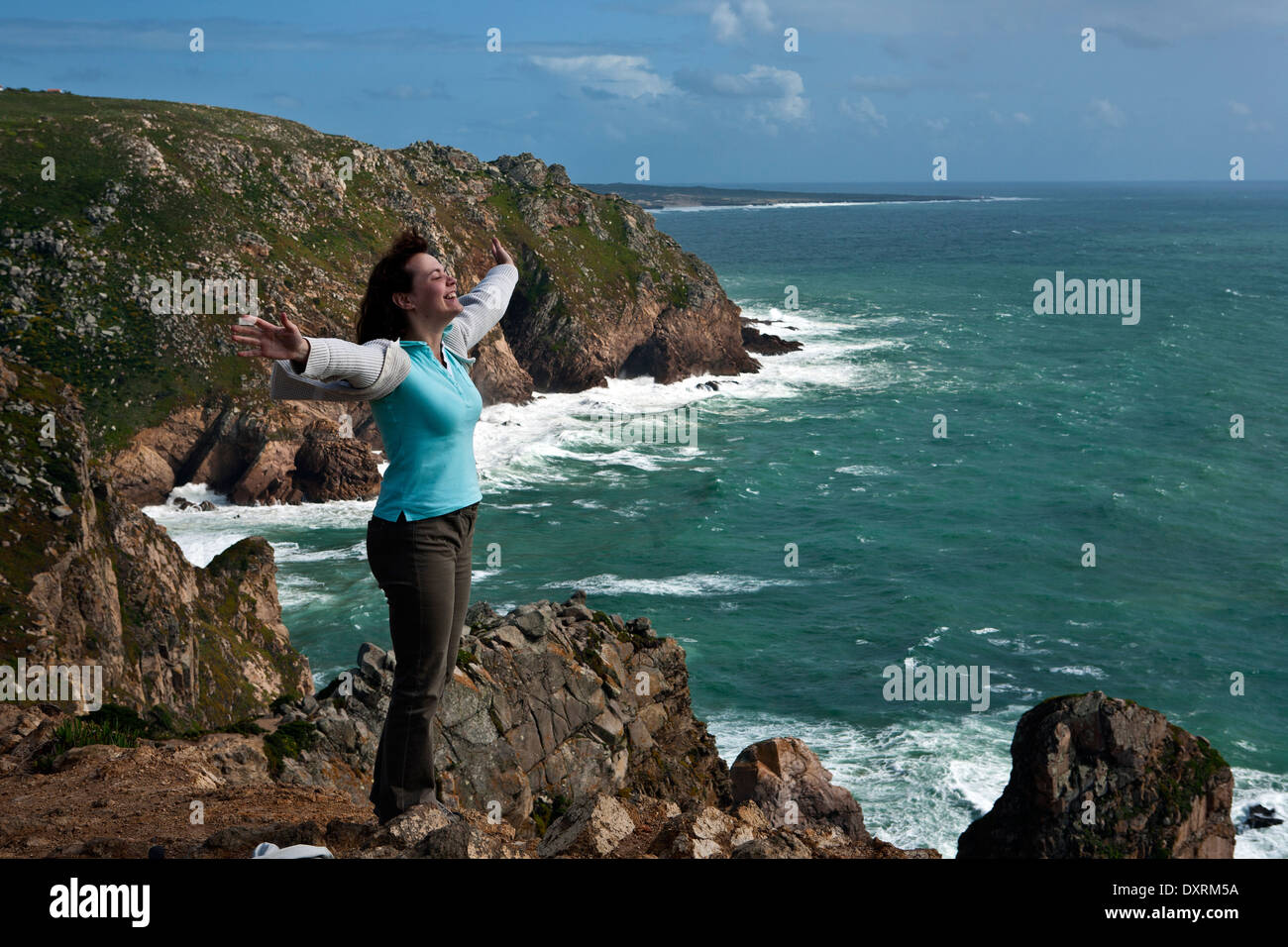 Woman standing at the edge of Cabo da Roca cliffs Portugal Stock Photo
