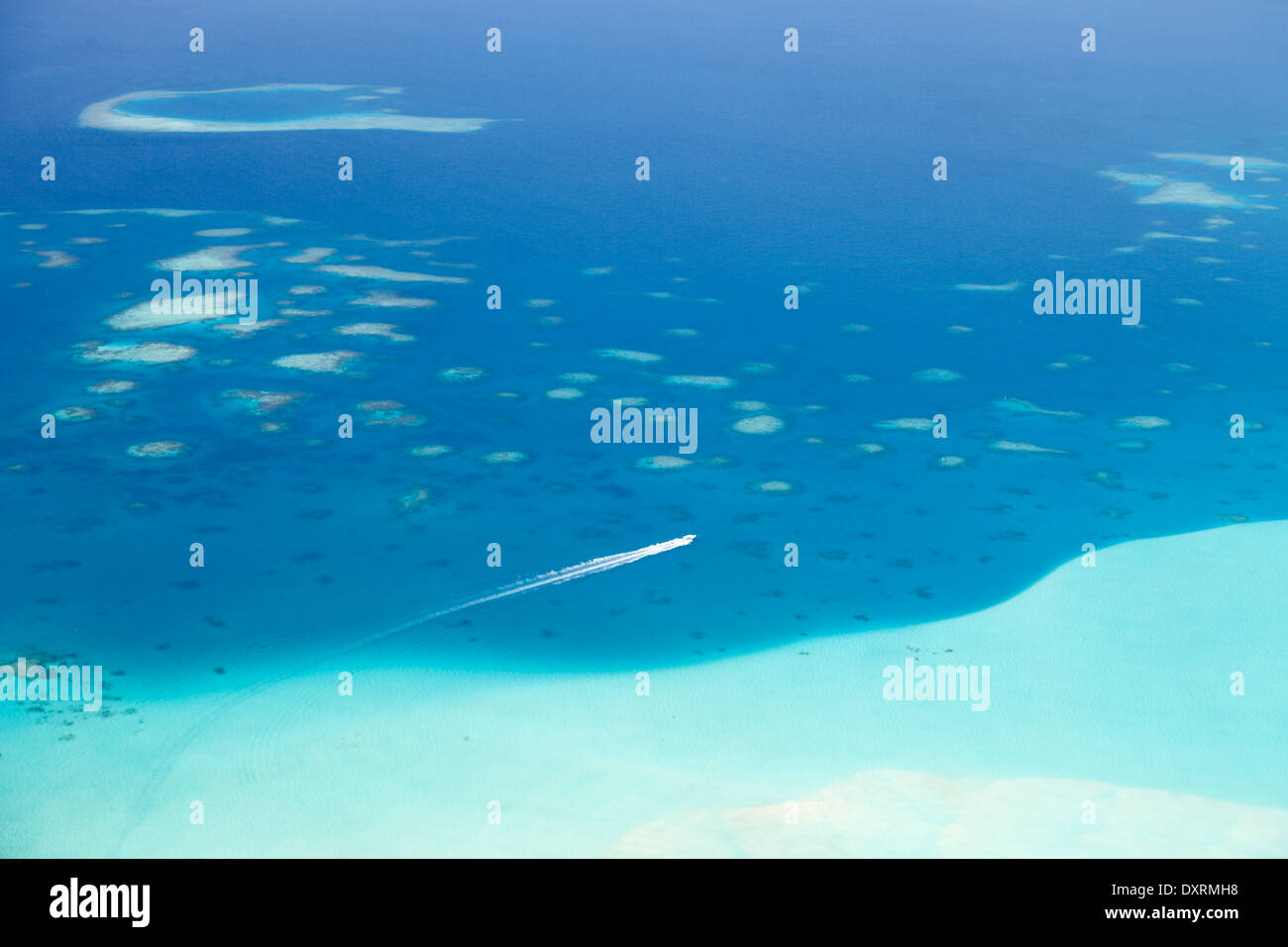 View from the window of an airplane flying above the Maldive Islands in the Indian Ocean 13 Stock Photo