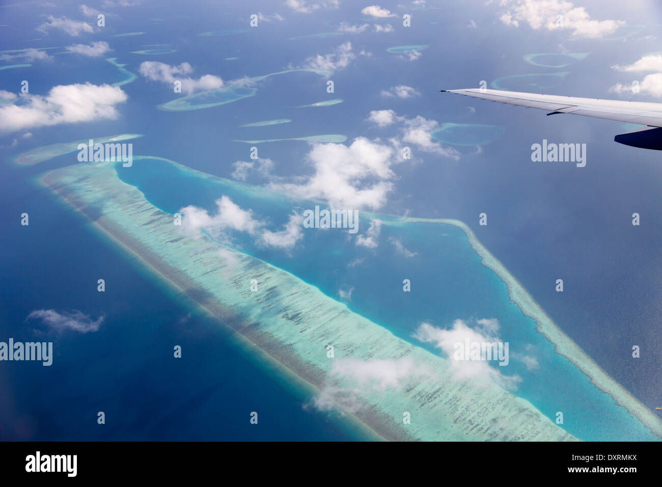 View from the window of an airplane flying above the Maldive Islands in the Indian Ocean 5 Stock Photo