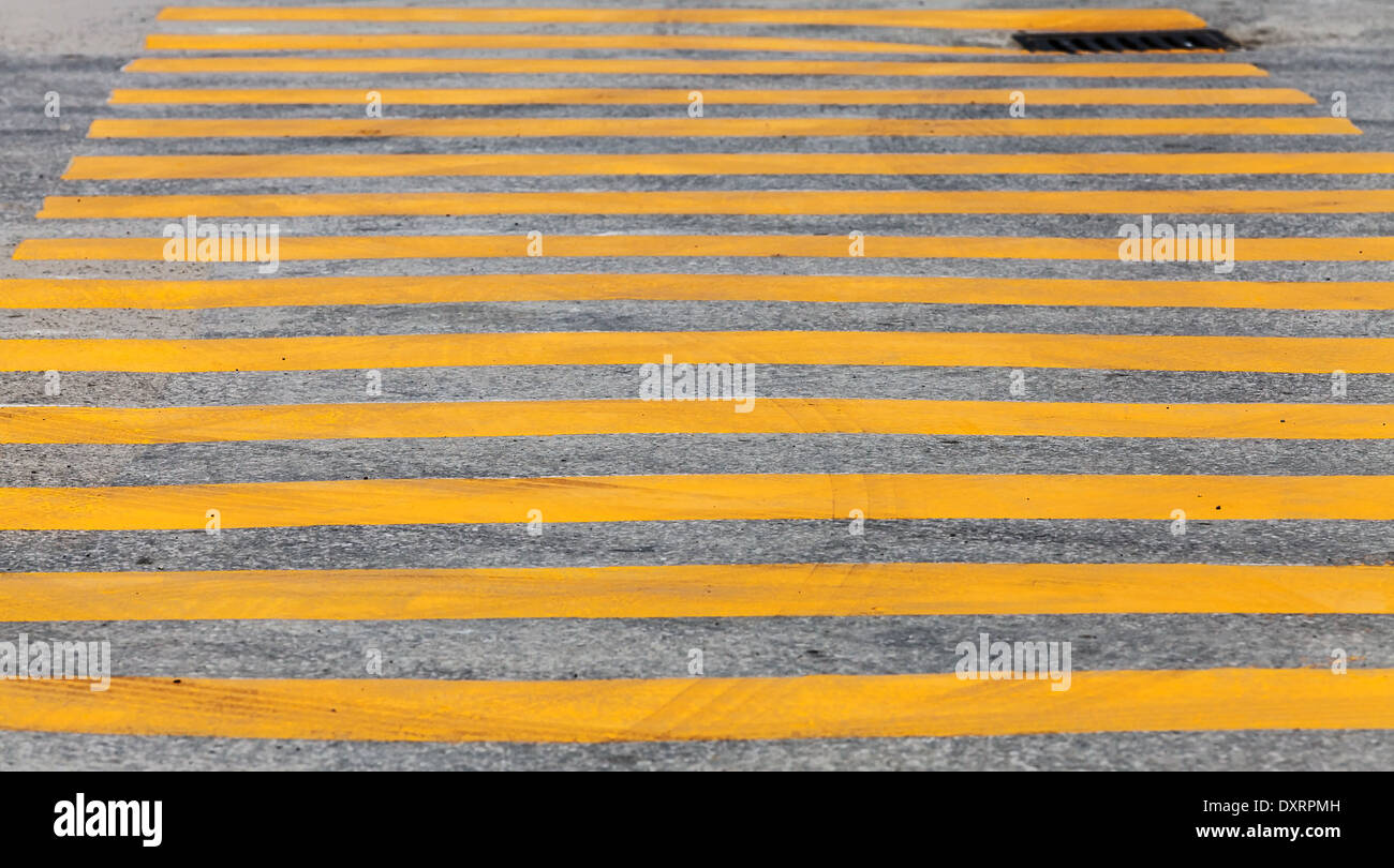 Pedestrian crossing road marking with yellow stripes on asphalt Stock Photo