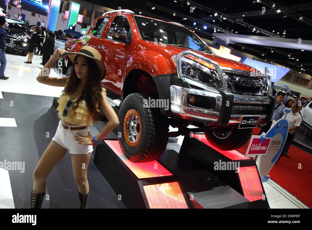 Bangkok, Thailand. 28th March 2014.  Presenter posing with Isuzu D-Max during The 35th Bangkok International Motor Show . The 35th Bangkok International Motor Show; will be held from March 26 to April 6 Credit:  John Vincent/Alamy Live News Stock Photo