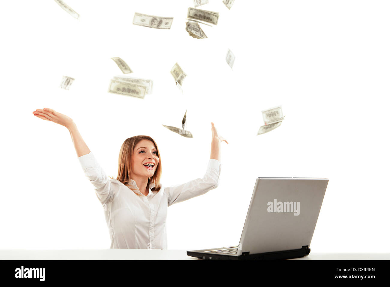 Young woman with laptop and flying money. Isolated over white ...