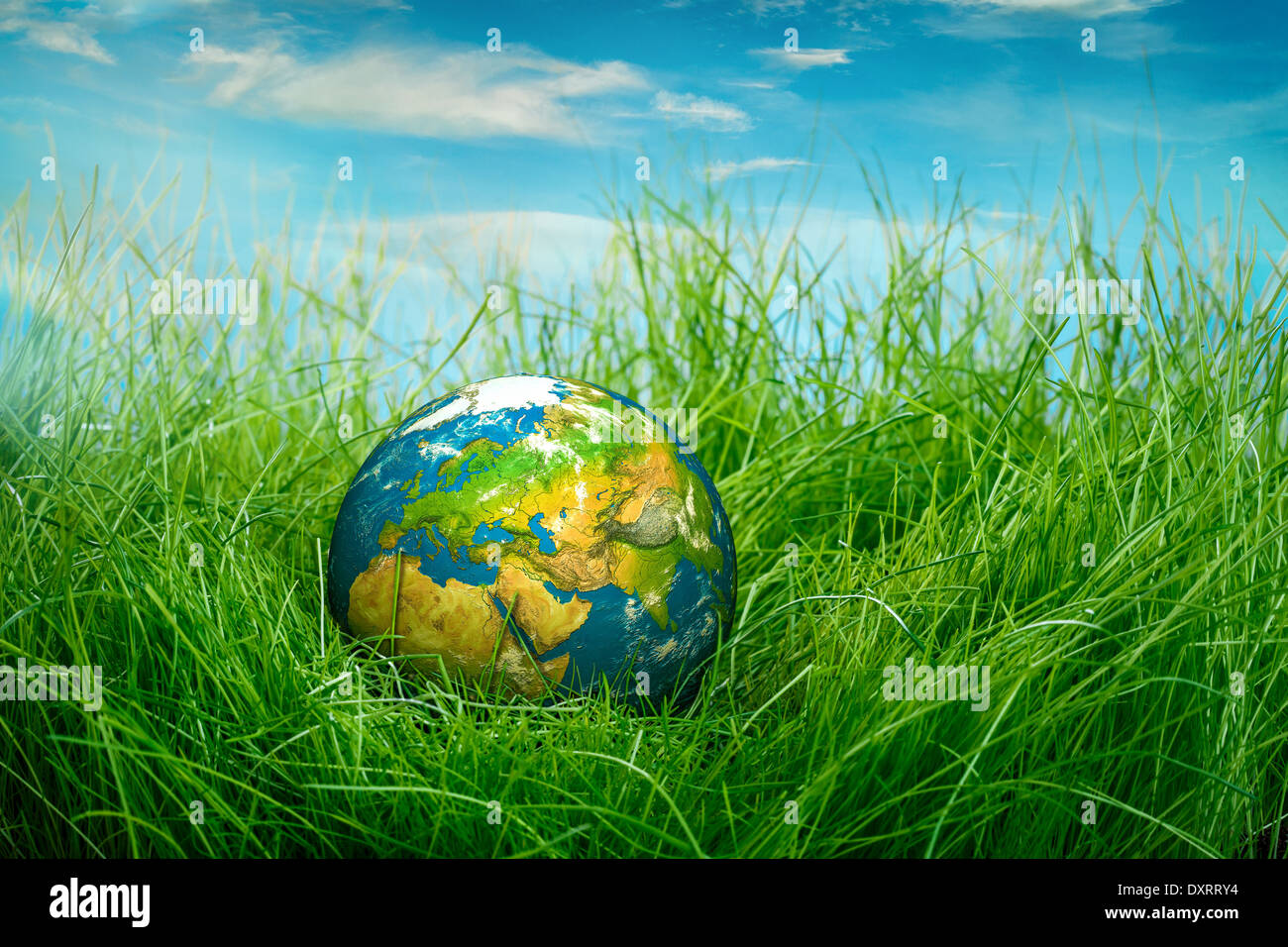 Globe lies on green grass. Concept - Earth Day Stock Photo - Alamy