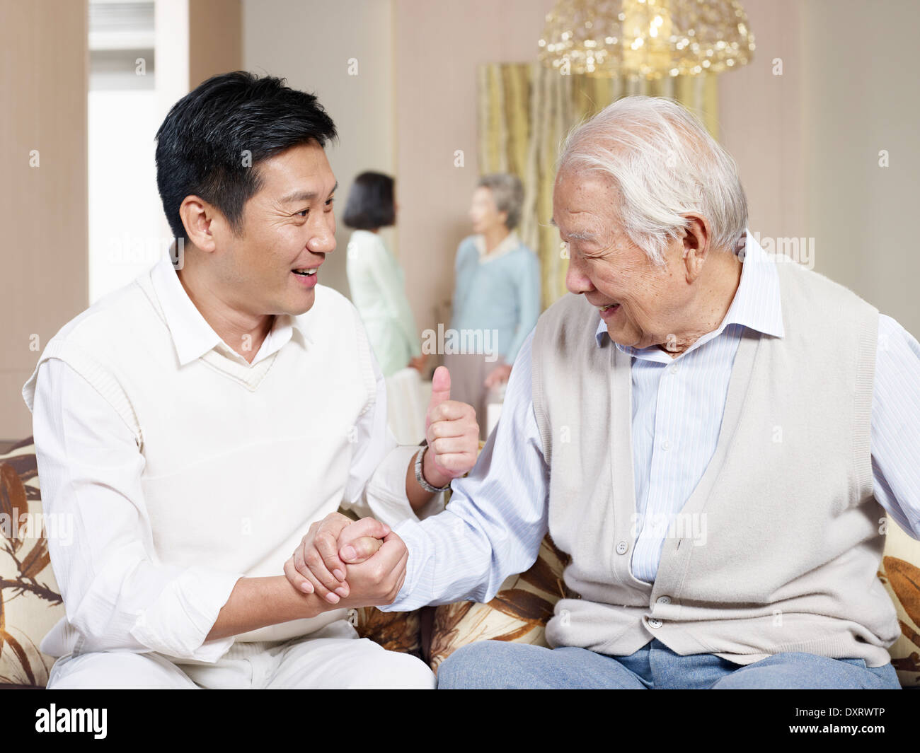 senior father and adult son chatting Stock Photo