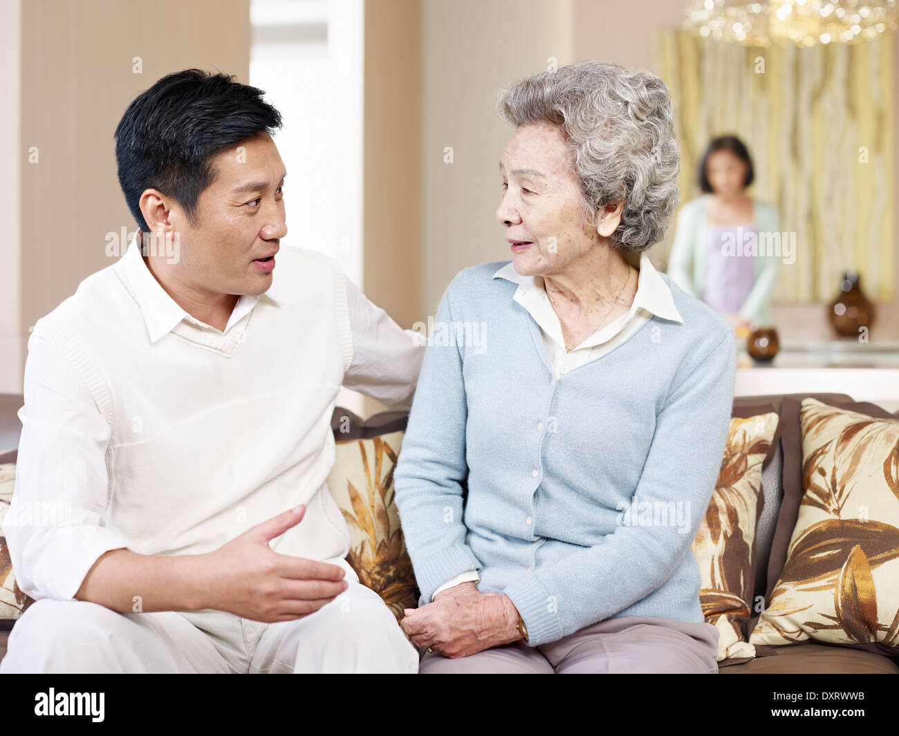 senior mother and adult son chatting Stock Photo