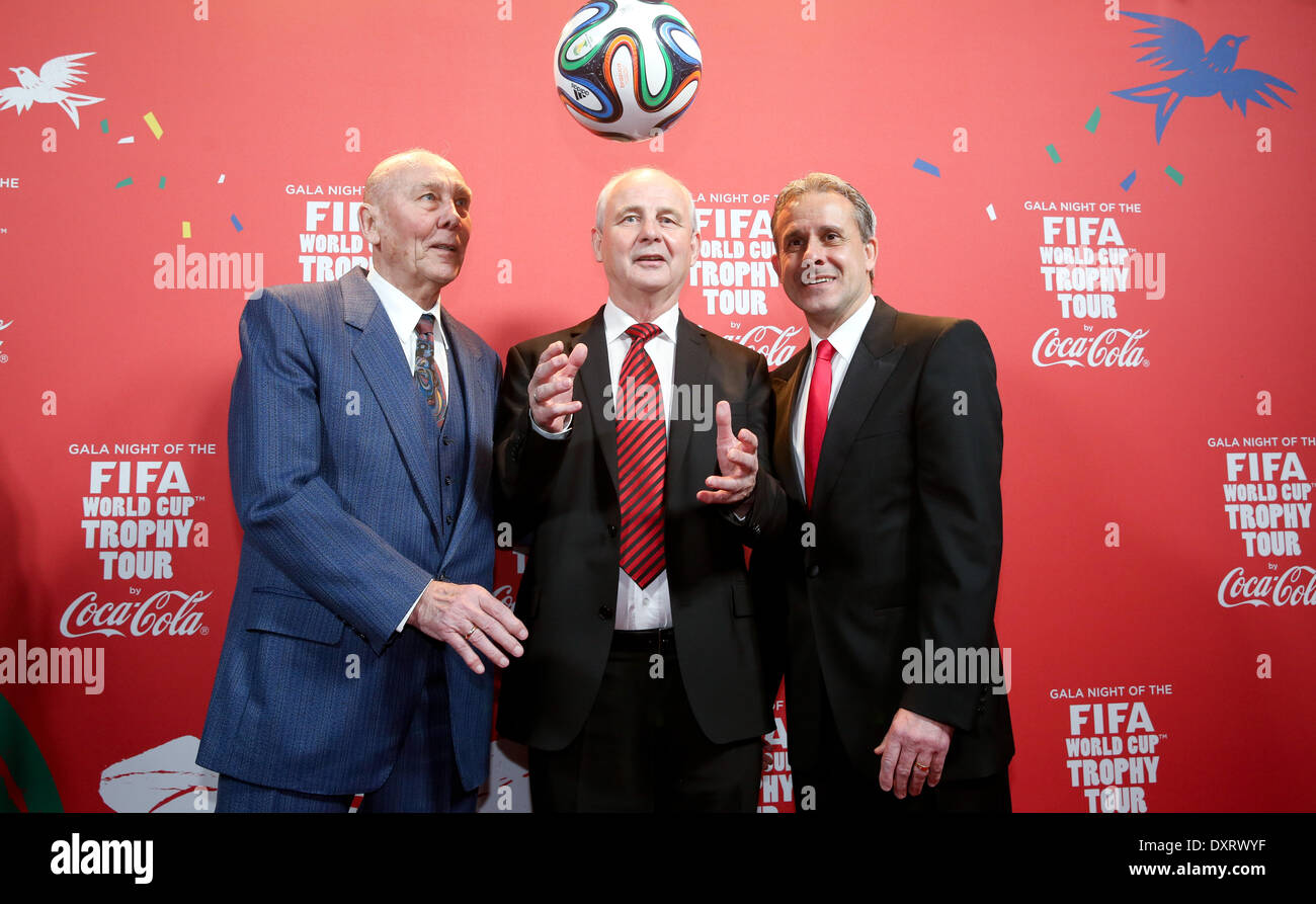 Berlin, Germany. 29th Mar, 2014. Former German national soccer players and world champions of 1954 Horst Eckel (L-R), Bernd Hoelzenbein of 1974 and Pierre Littbarski of 1990 pose on stage during a gala which took place on the occasion of the FIFA world cup tour in Berlin, Germany, 29 March 2014. The FIFA World CUp trophy is touring across the glob through 90 countries in preparation for the forthcoming soccer world cup in Brazil. Photo: Kay Nietfeld/dpa/Alamy Live News Stock Photo