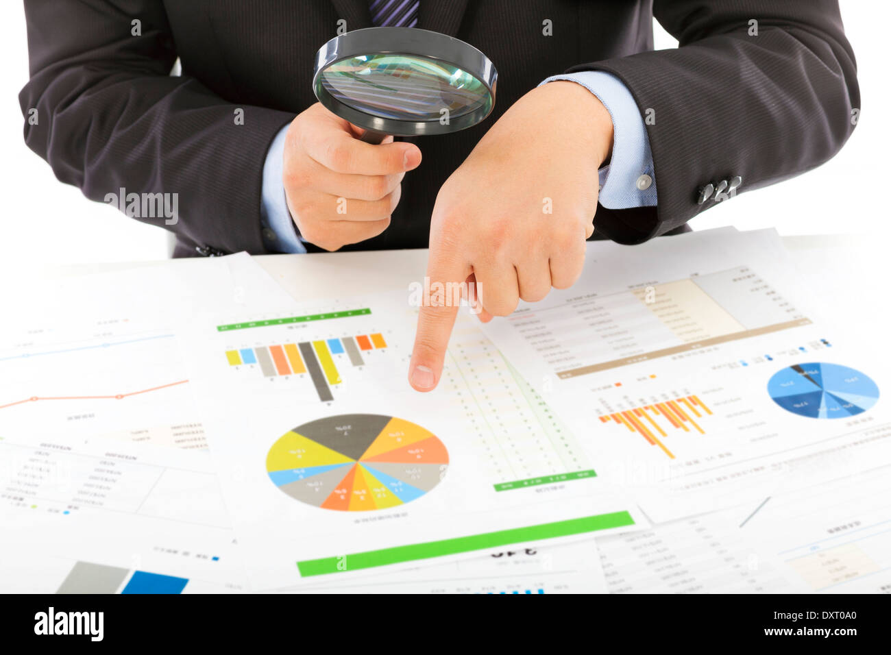 businessman hold a magnifying glass to explore Stock Photo