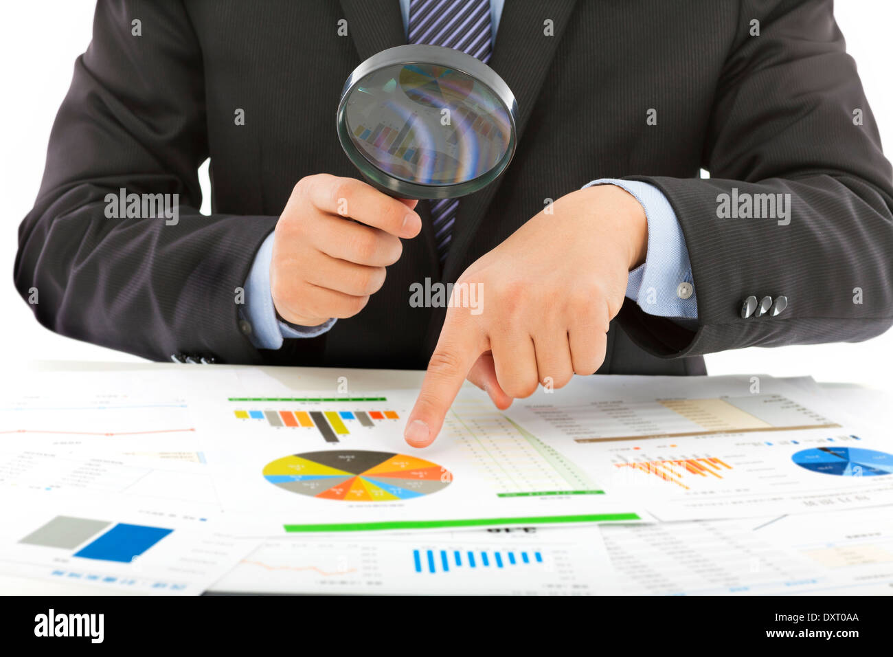 businessman hold a magnifying glass to check in office Stock Photo