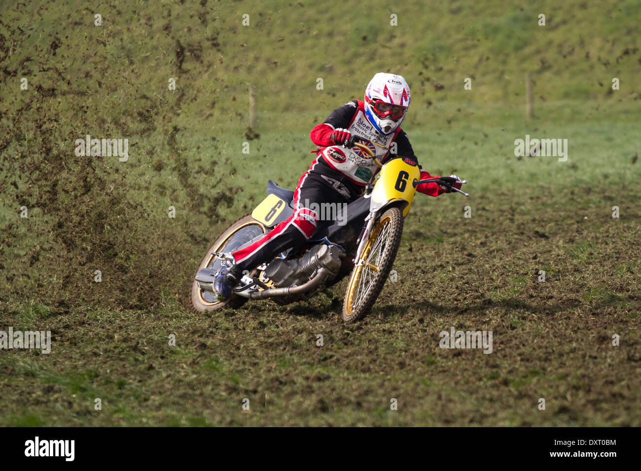 Youngsters grass track motorcycle riding in Much Hoole, Lancashire, UK 30th March, 2014. Rob Finlow No.6  MX65 racer at the first ever meeting of the Lancashire Offroad Grasstrack Association held at Lower Marsh Farm, Much Hoole, Preston. A junior motorcycle race, grass track, speed, bike, motorbike, motorsport, power, winner, racing, motocross, competition, extreme sports, helmet, wheel, moto, sport, rider, cross, fun, jump, riding, sports, trail, dirt, fast event held under the National Sporting Code rules of the ACU standing regulations for grass tracks. Stock Photo