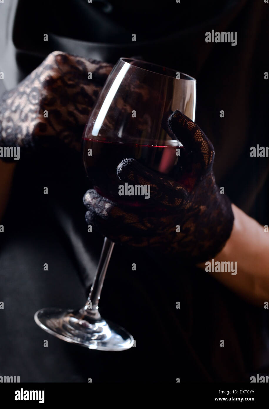 woman in black gloves with glass of red wine Stock Photo - Alamy