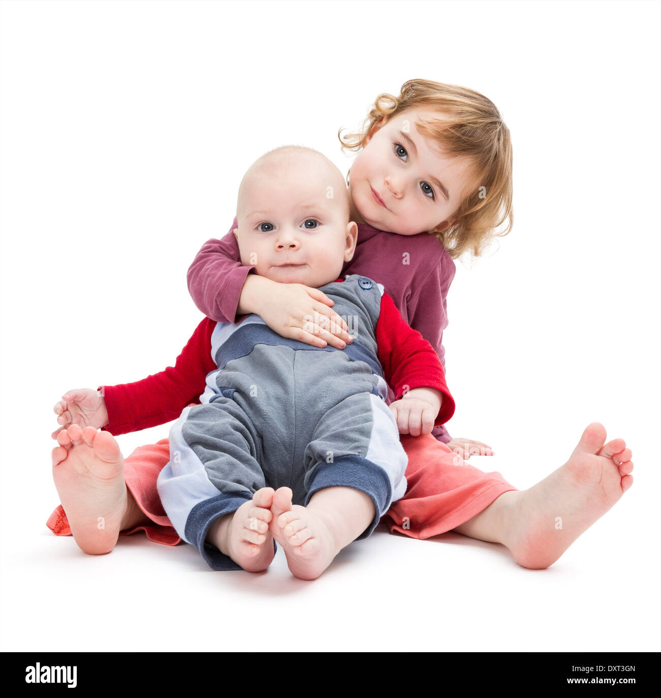 boy and girl sitting on floor. isolated on white background Stock Photo