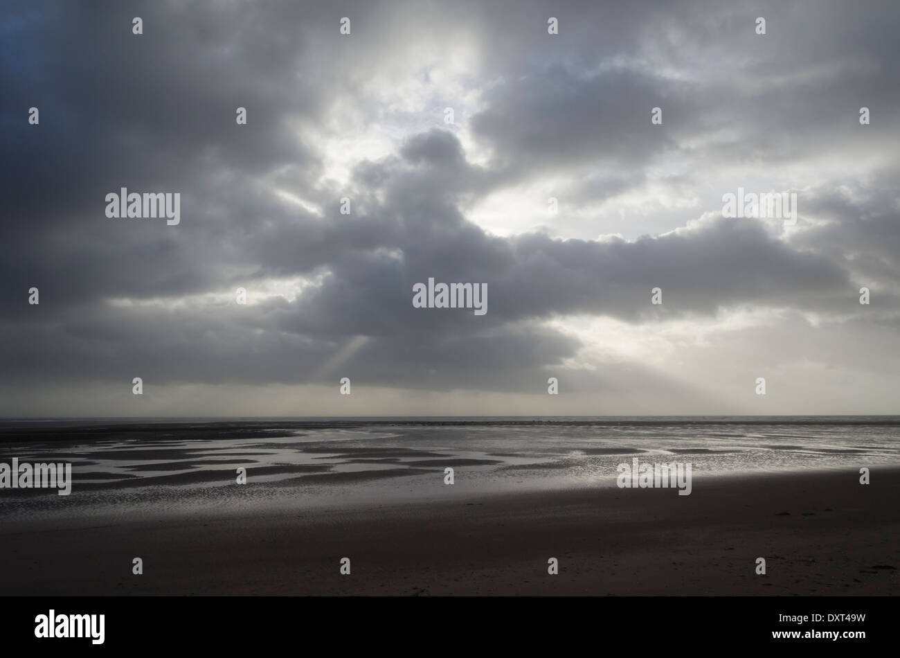 Stormy January sky over Drigg's beach. The timid afternoon winter sun
