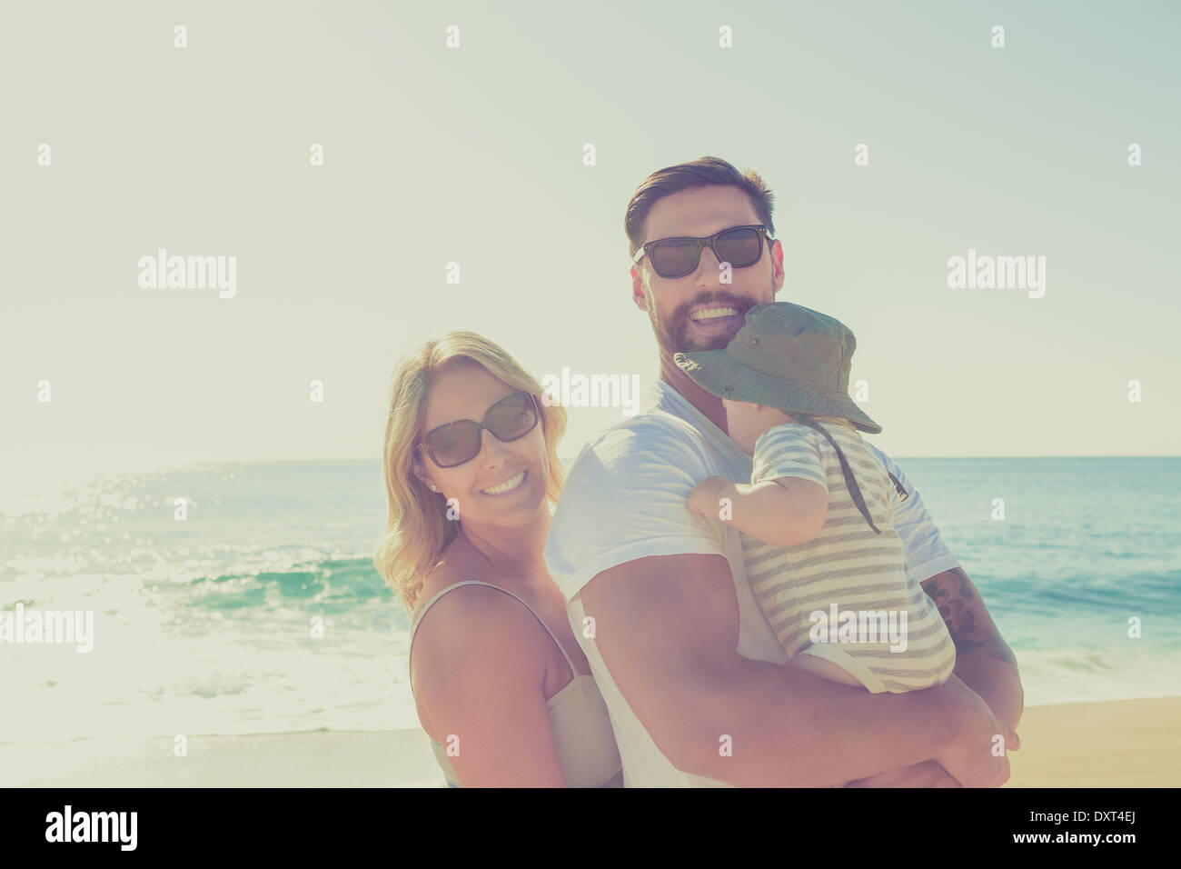 Portrait of happy family on sunny beach Stock Photo