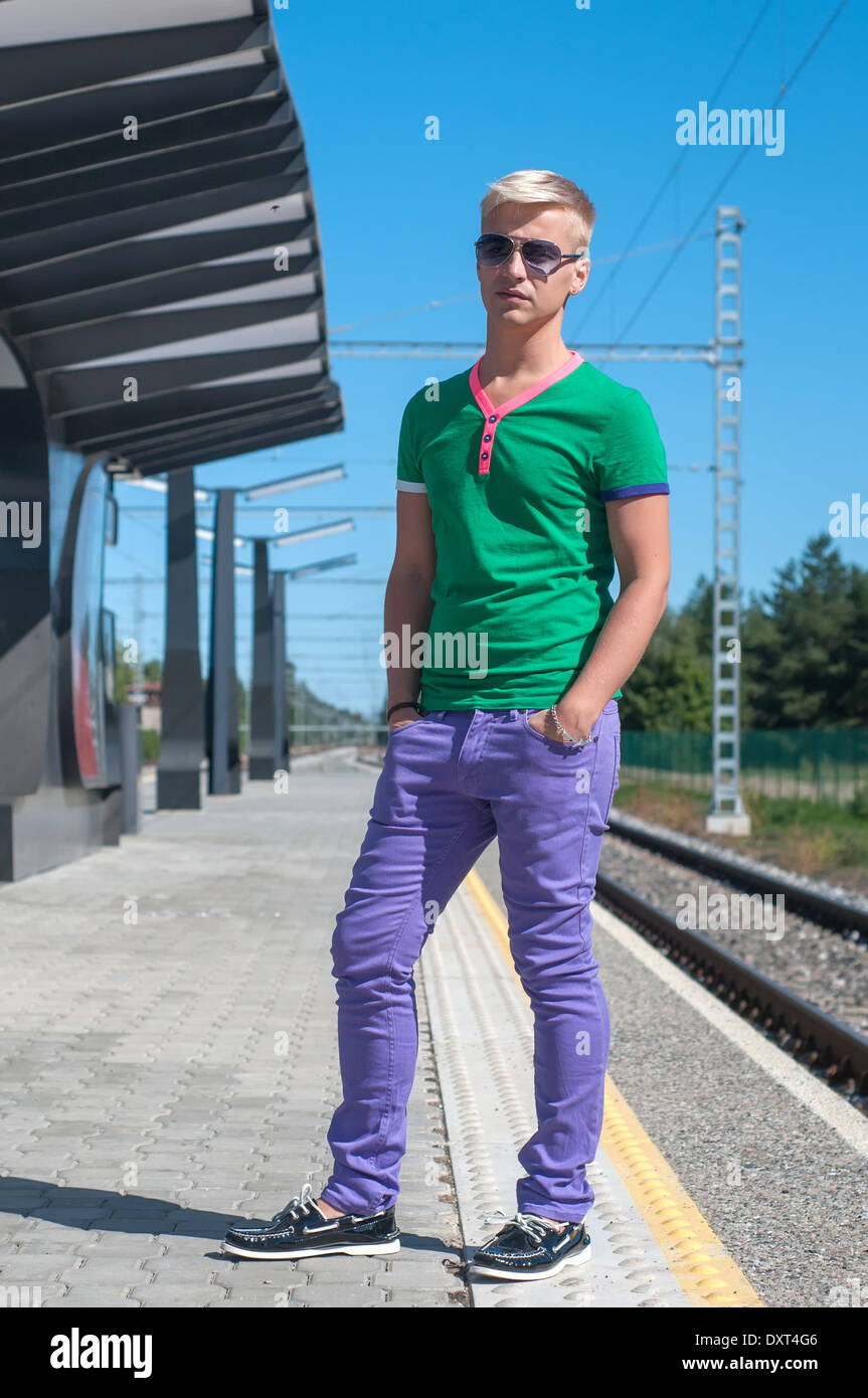 Stylish man with sun glasses standing on platform Stock Photo