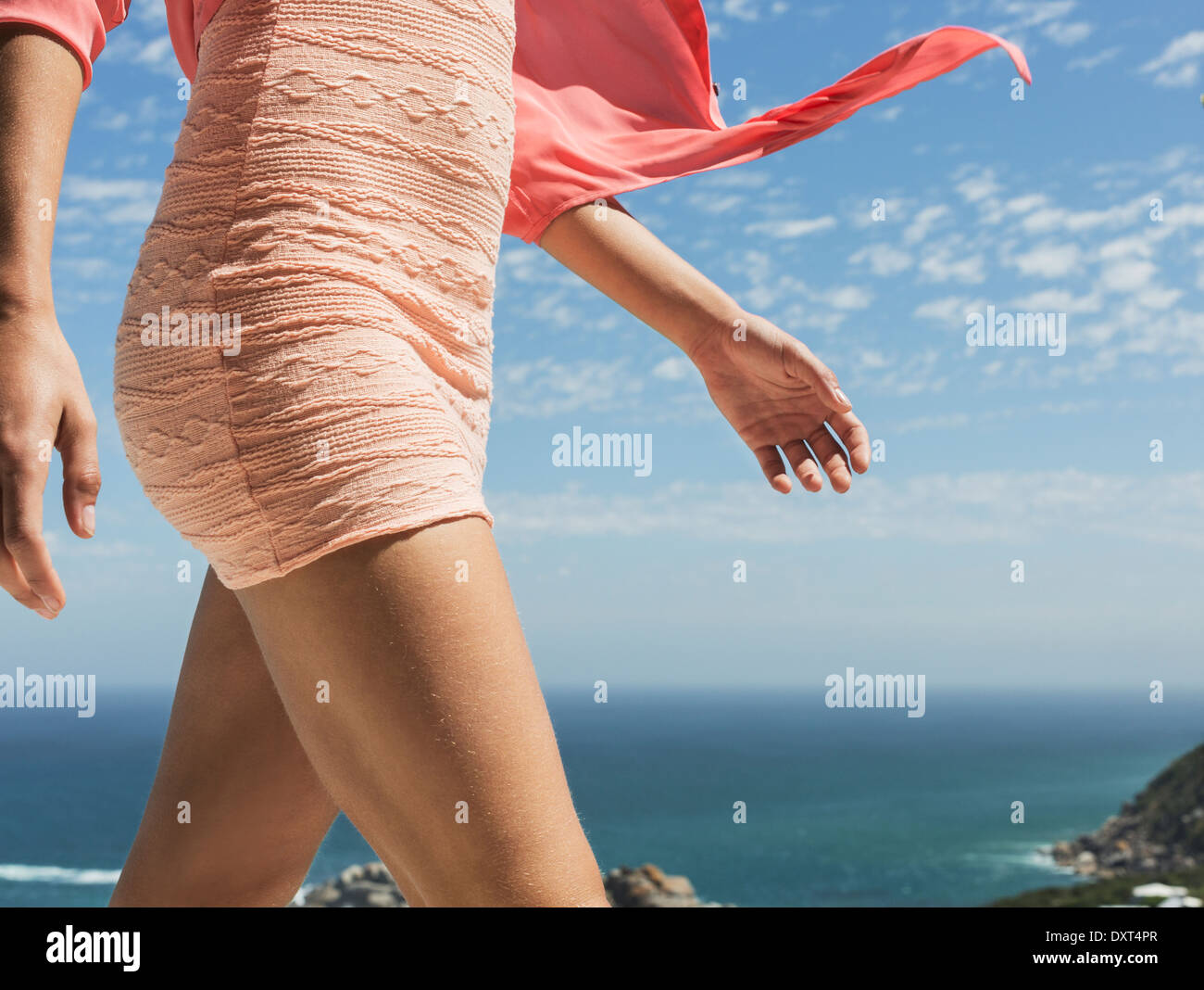 Close up of woman walking with ocean in background Stock Photo