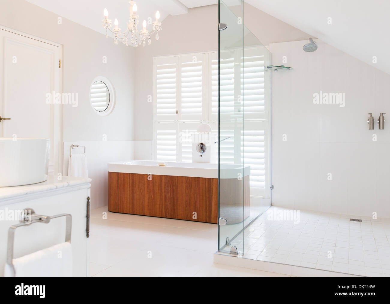 Chandelier over soaking tub in modern bathroom Stock Photo Alamy