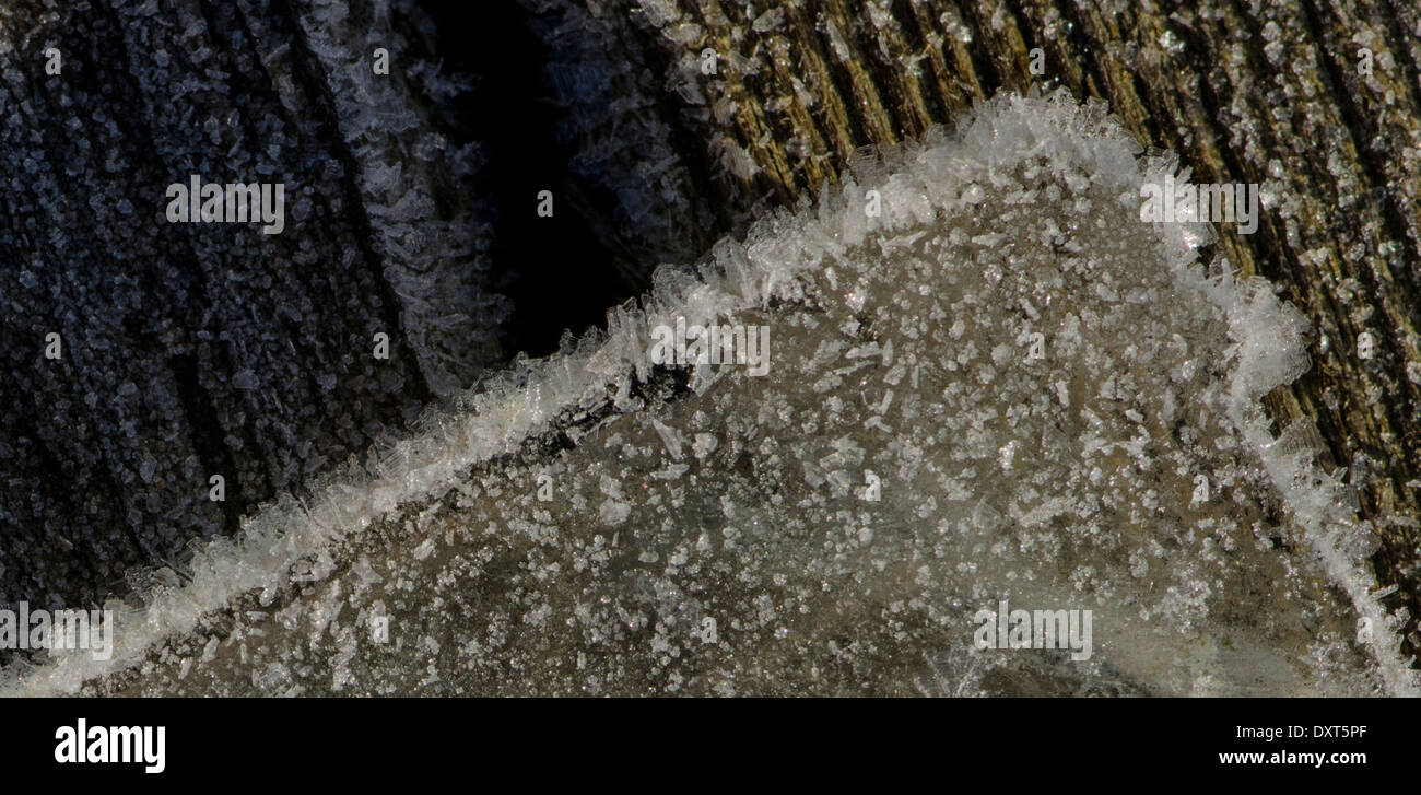 close up of frozen ice chunk against wood Stock Photo