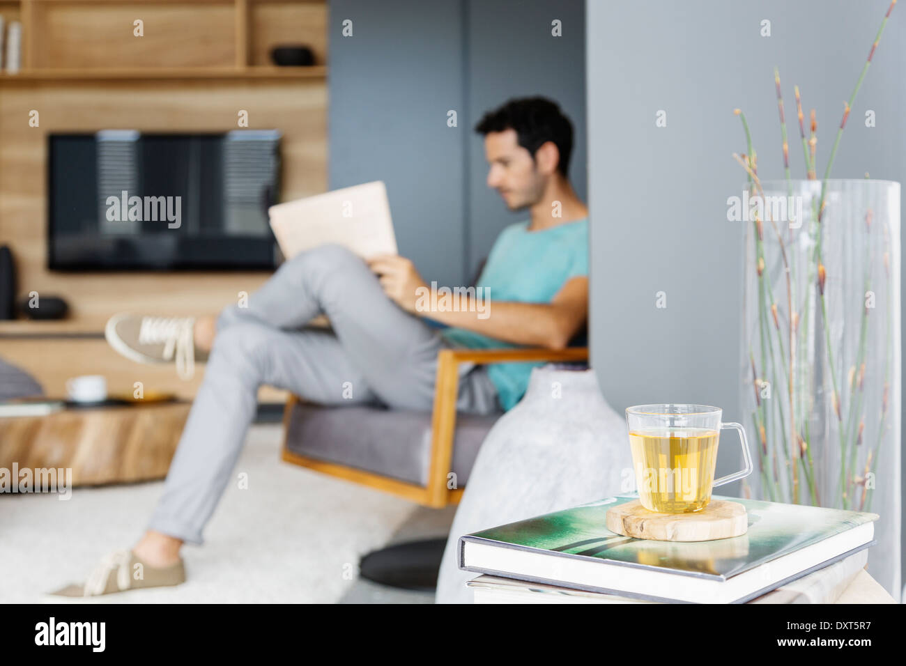 Man reading newspaper in living room Stock Photo