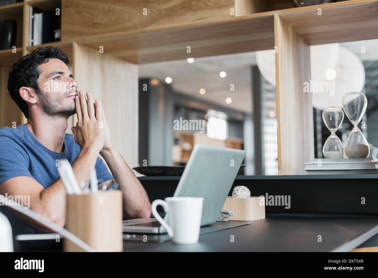 Pensive man at laptop in home office Stock Photo