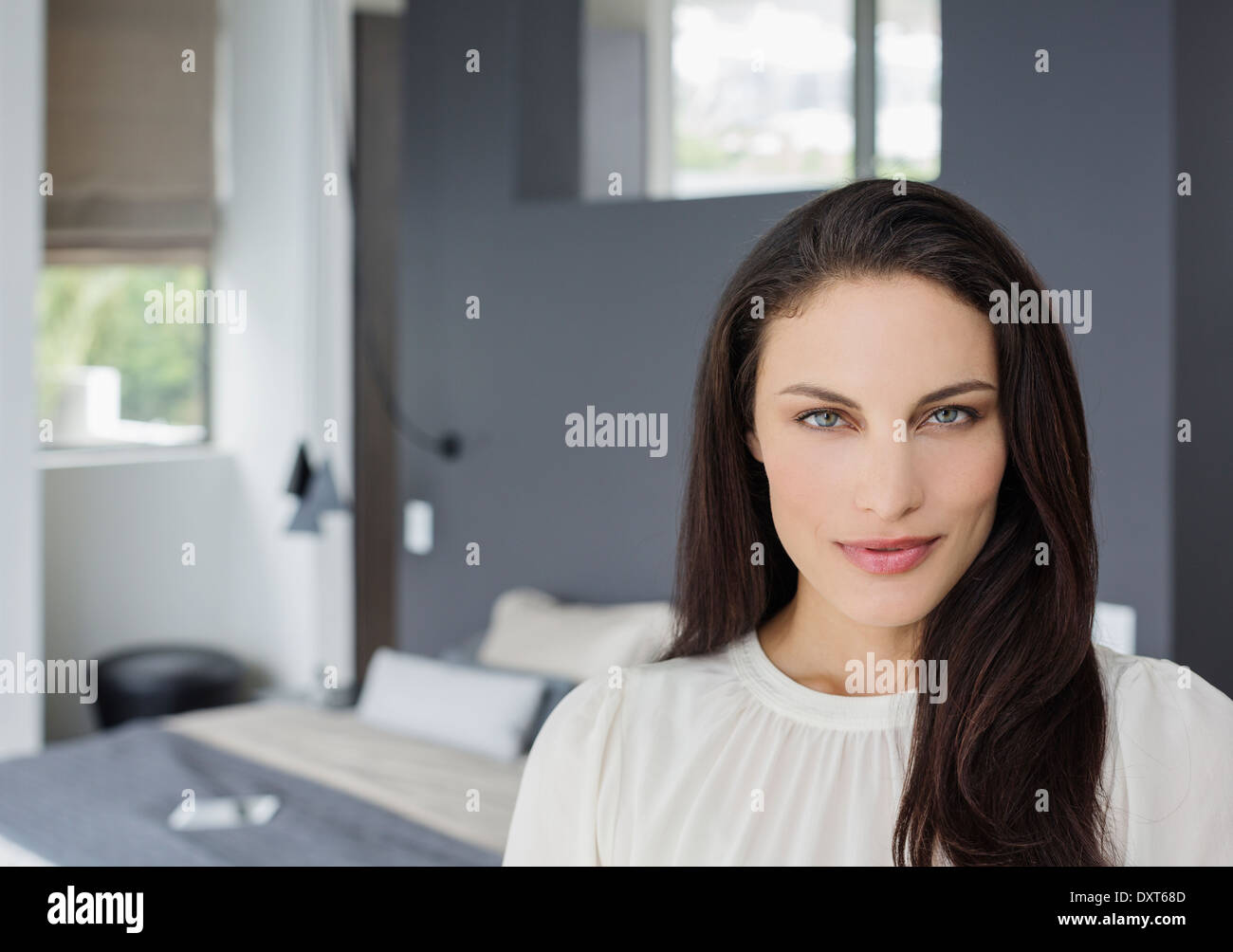 Portrait of confident woman in bedroom Stock Photo