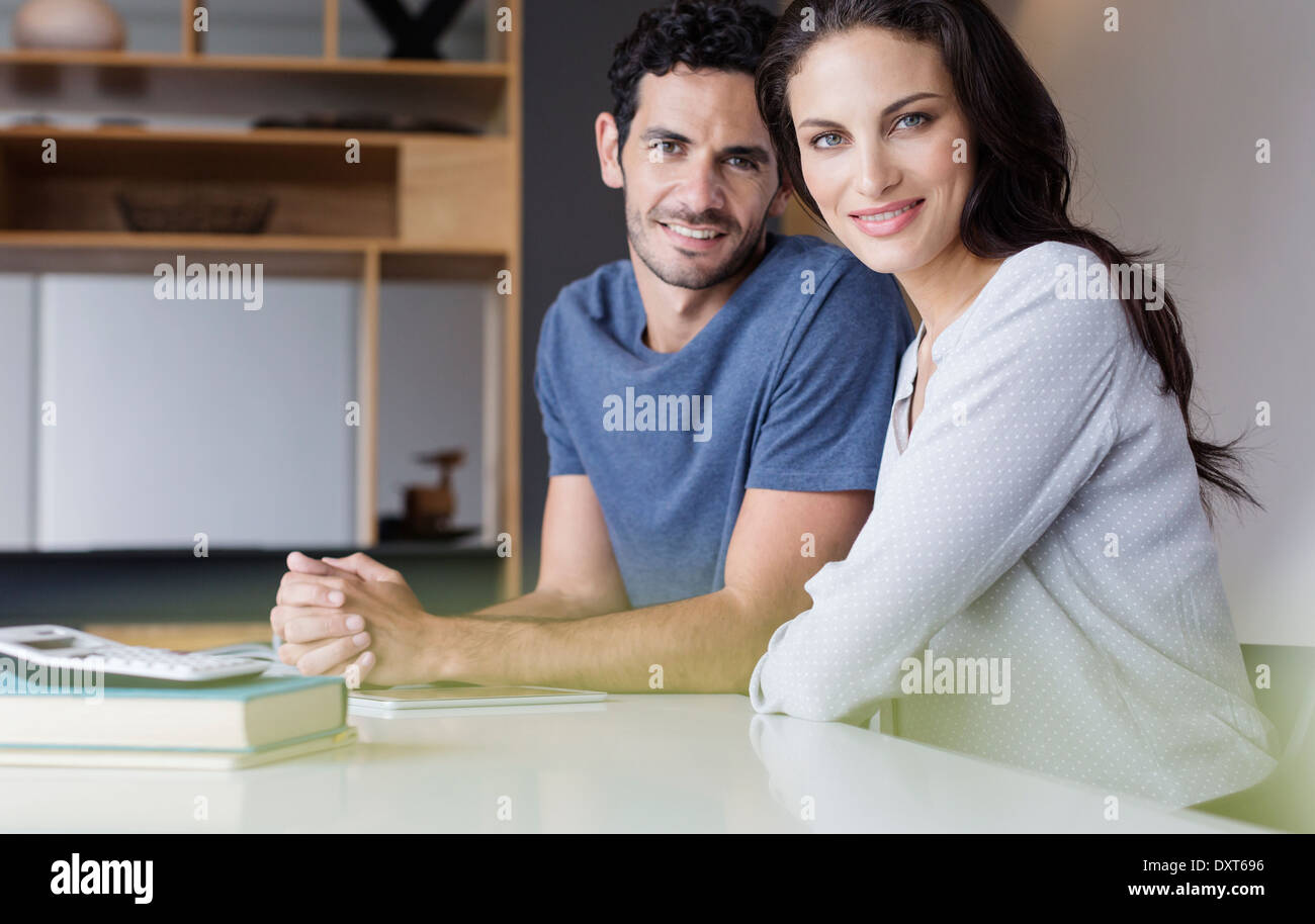 Portrait of smiling couple at table Stock Photo
