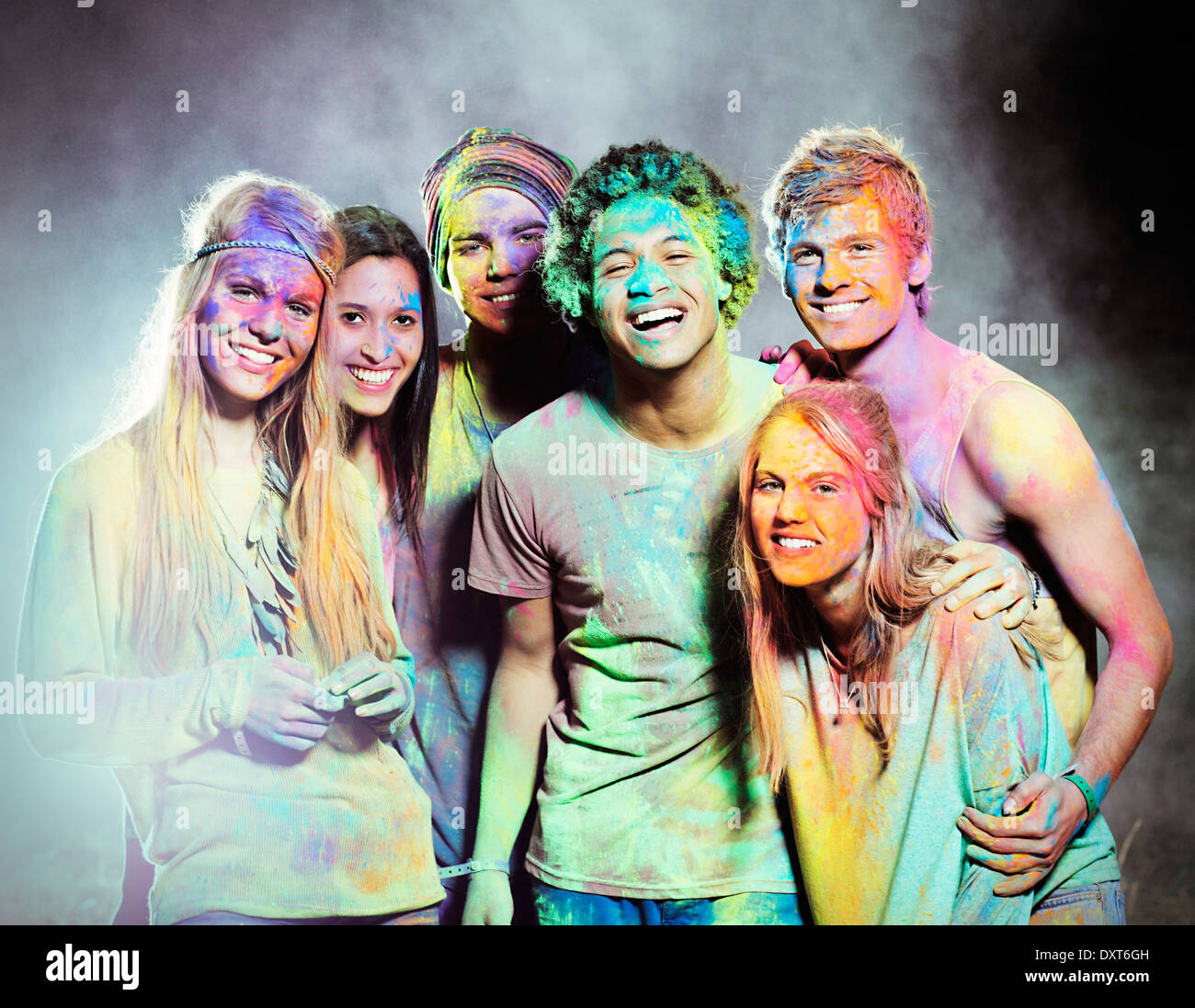 Portrait of friends covered in chalk dye at music festival Stock Photo