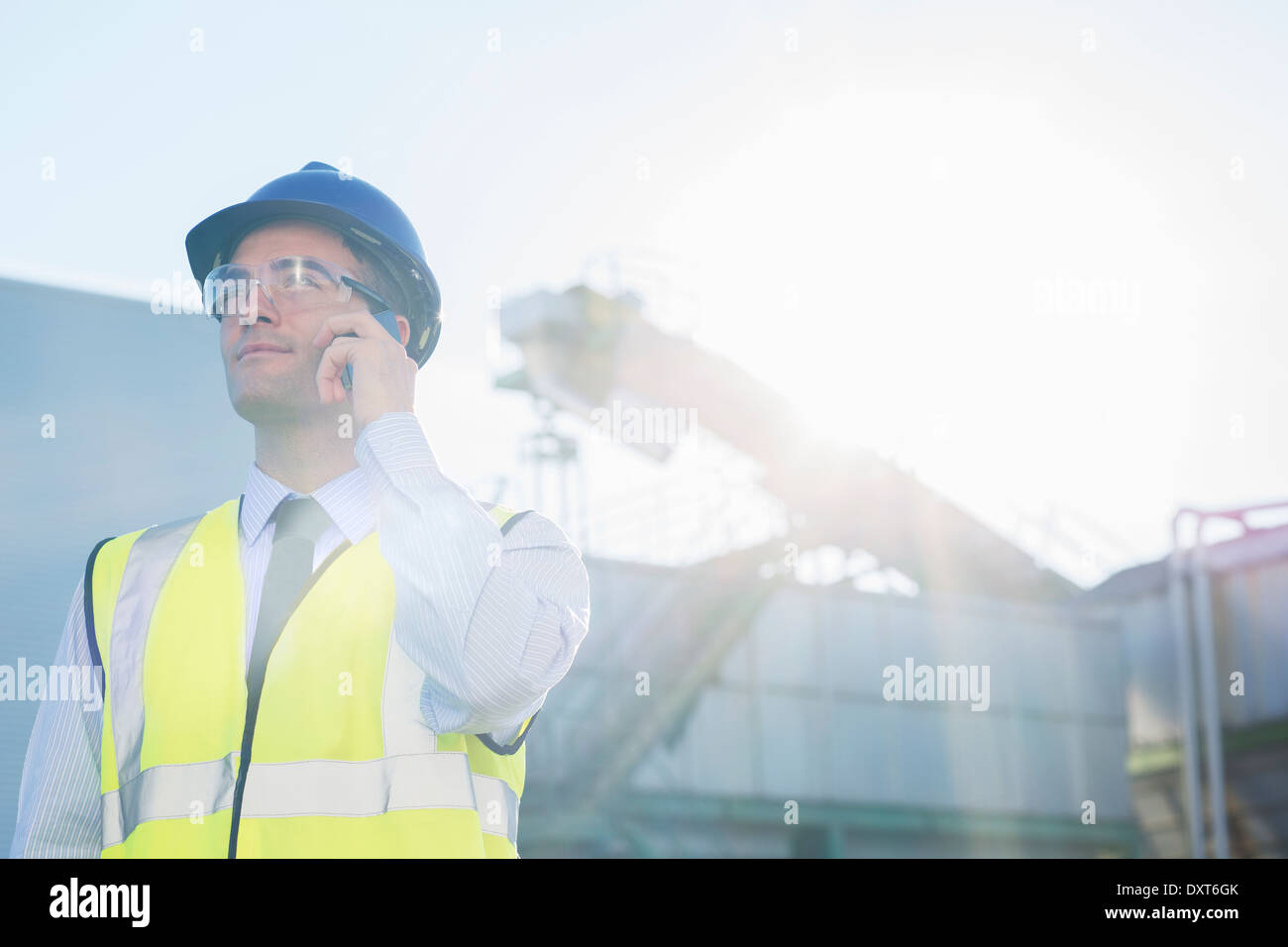 Worker talking on cell phone at granary Stock Photo