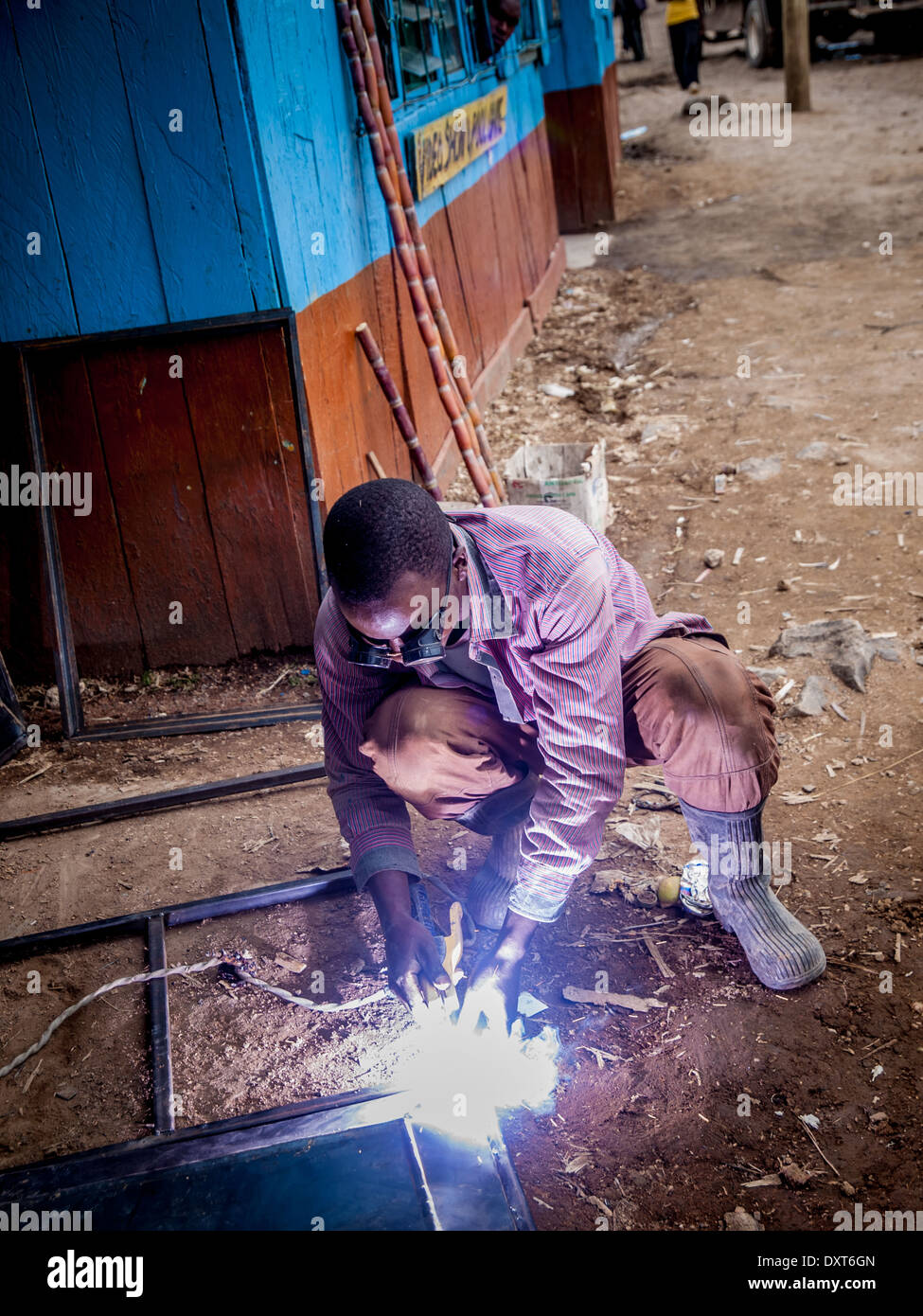 Welder in Kenya, Africa welds steel frames for doors and windows Stock