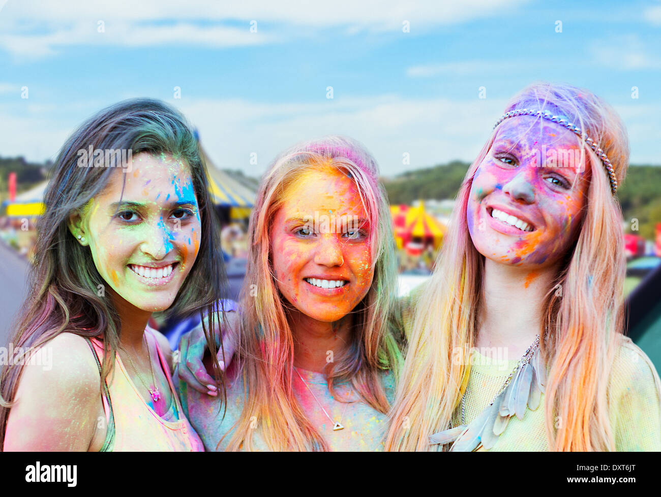 Portrait of smiling women covered in chalk dye at music festival Stock Photo
