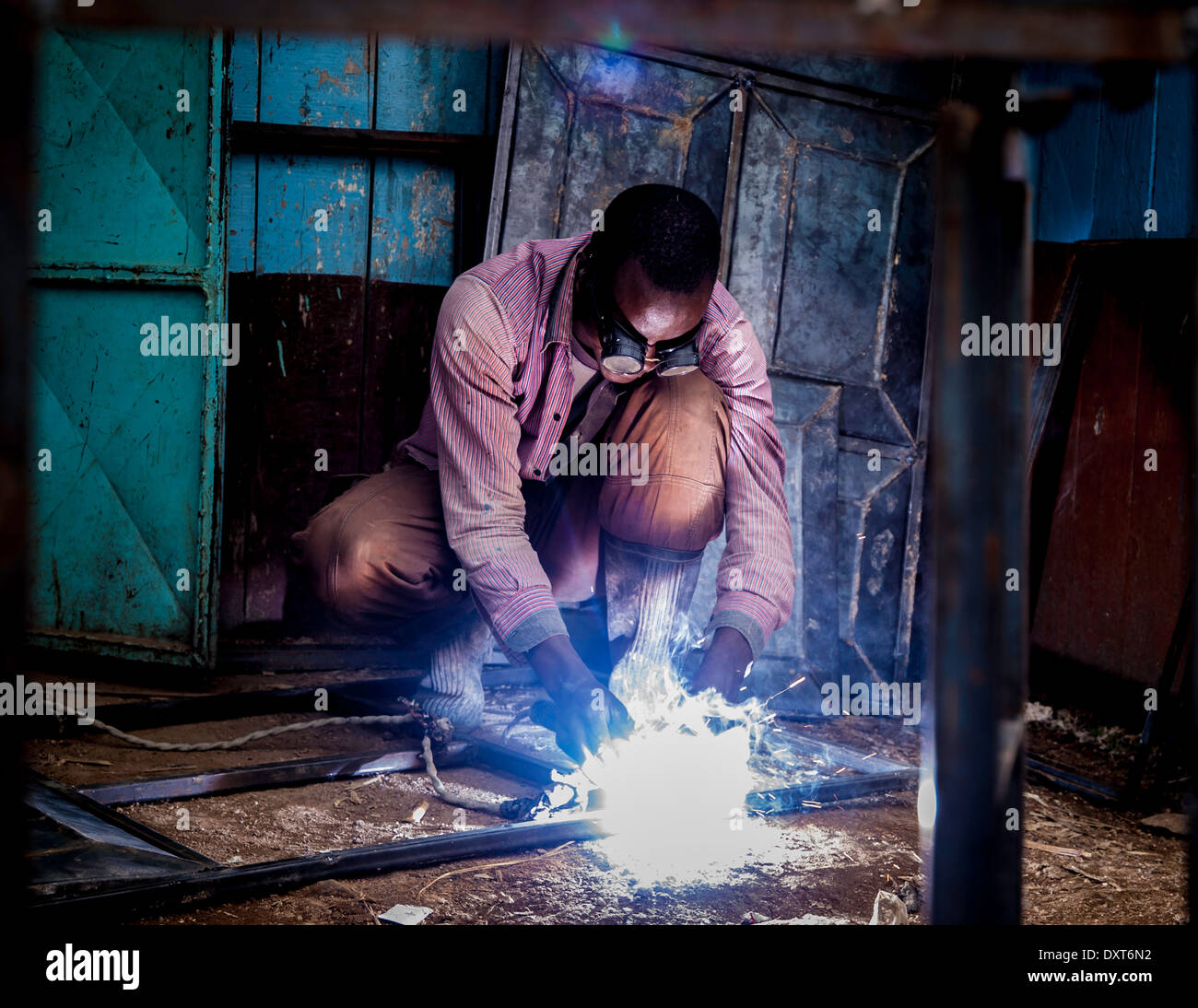 Welder in Kenya, Africa welds steel frames for doors and windows Stock