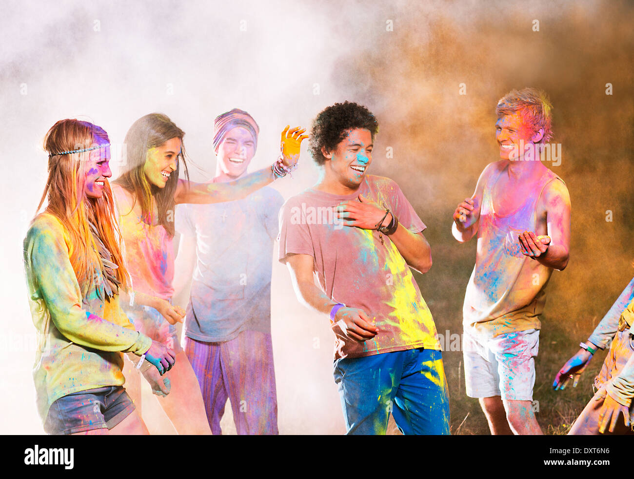 Friends covered in chalk dye at music festival Stock Photo