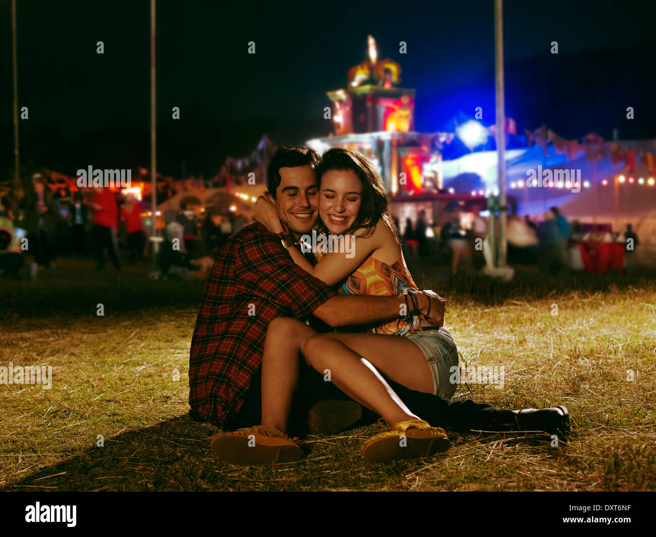 Happy couple hugging outside music festival Stock Photo