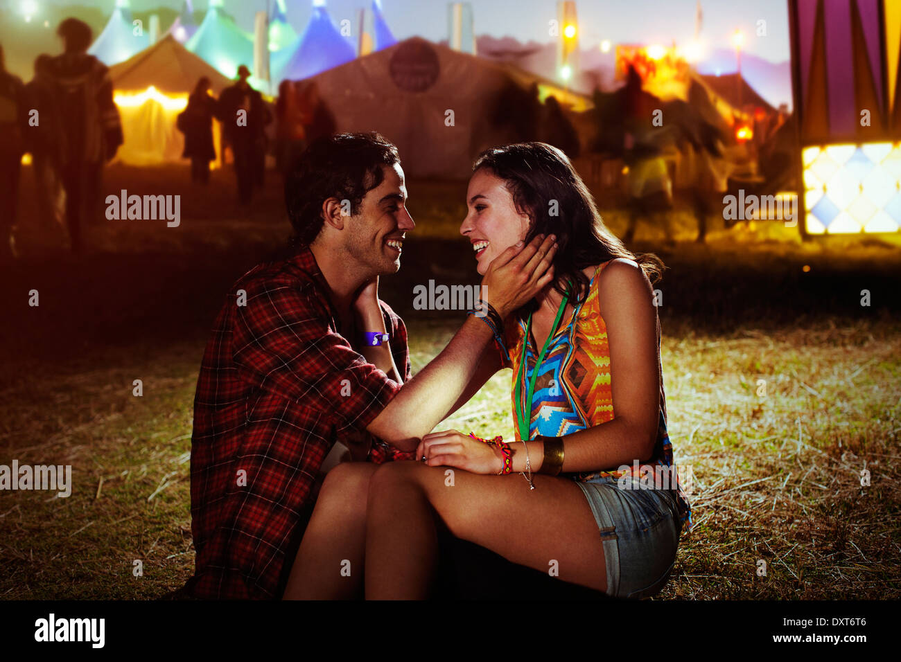 Affectionate couple outside music festival Stock Photo