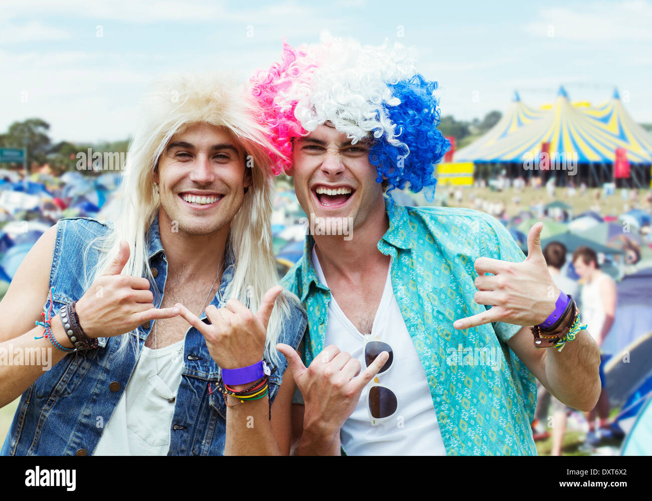 Portrait of men in wigs gesturing at music festival Stock Photo