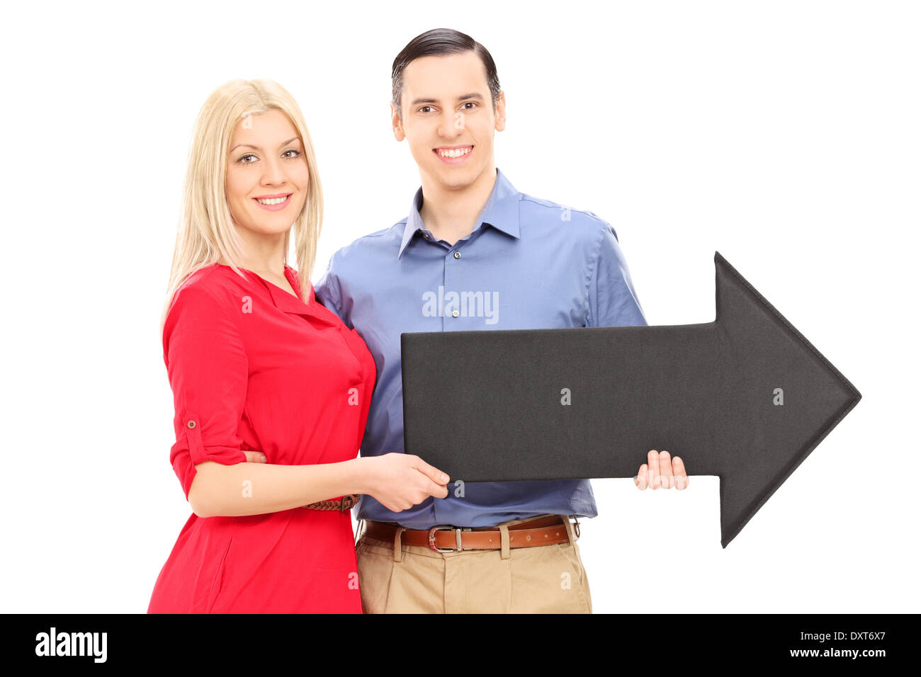 Young couple holding a big black arrow pointing right Stock Photo - Alamy
