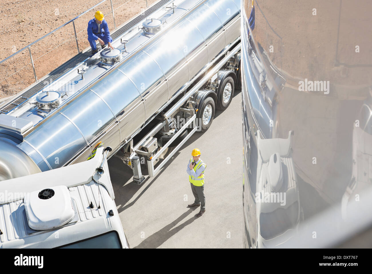 Workers around stainless steel milk tanker Stock Photo