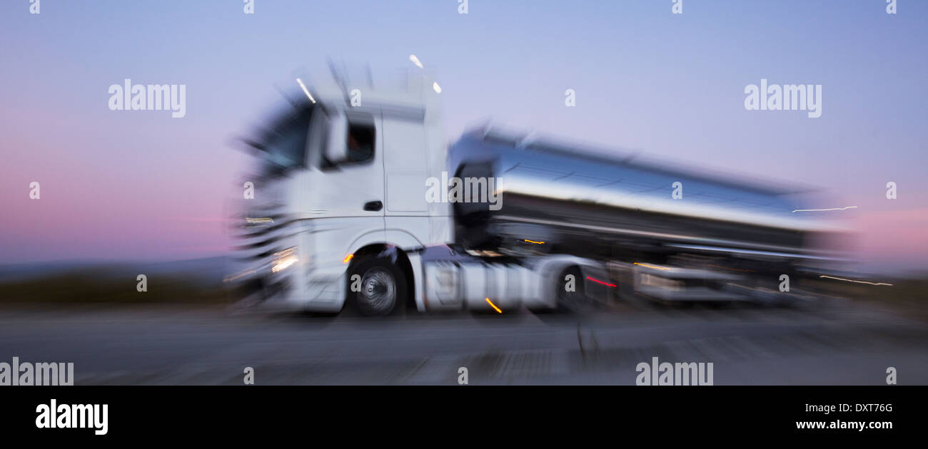 Stainless steel milk tanker on the road at night Stock Photo