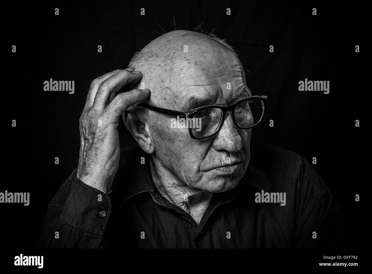 Artistic portrait of an old man with glasses Stock Photo