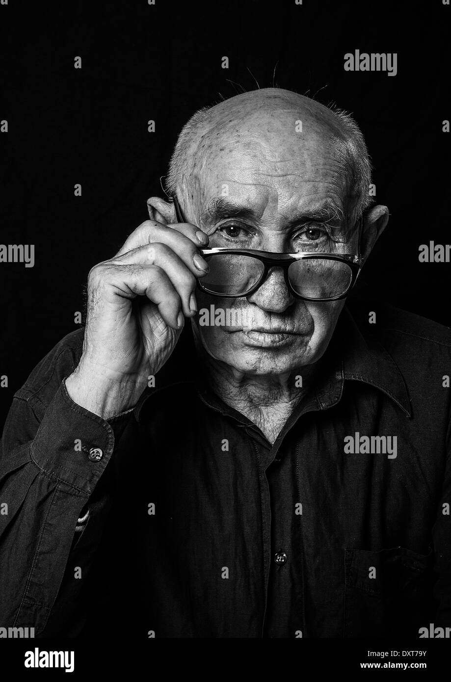 Black and White Portrait of an elderly man with a serious expression. Stock Photo