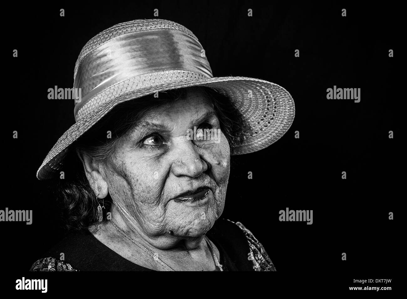 Portrait of the old woman in a hat on a black background Stock Photo