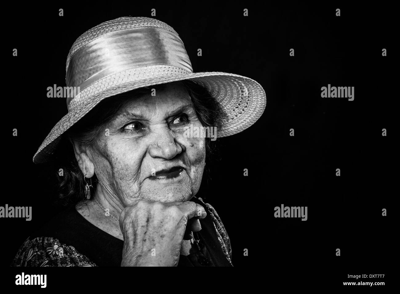 Portrait of the old woman in a hat on a black background Stock Photo