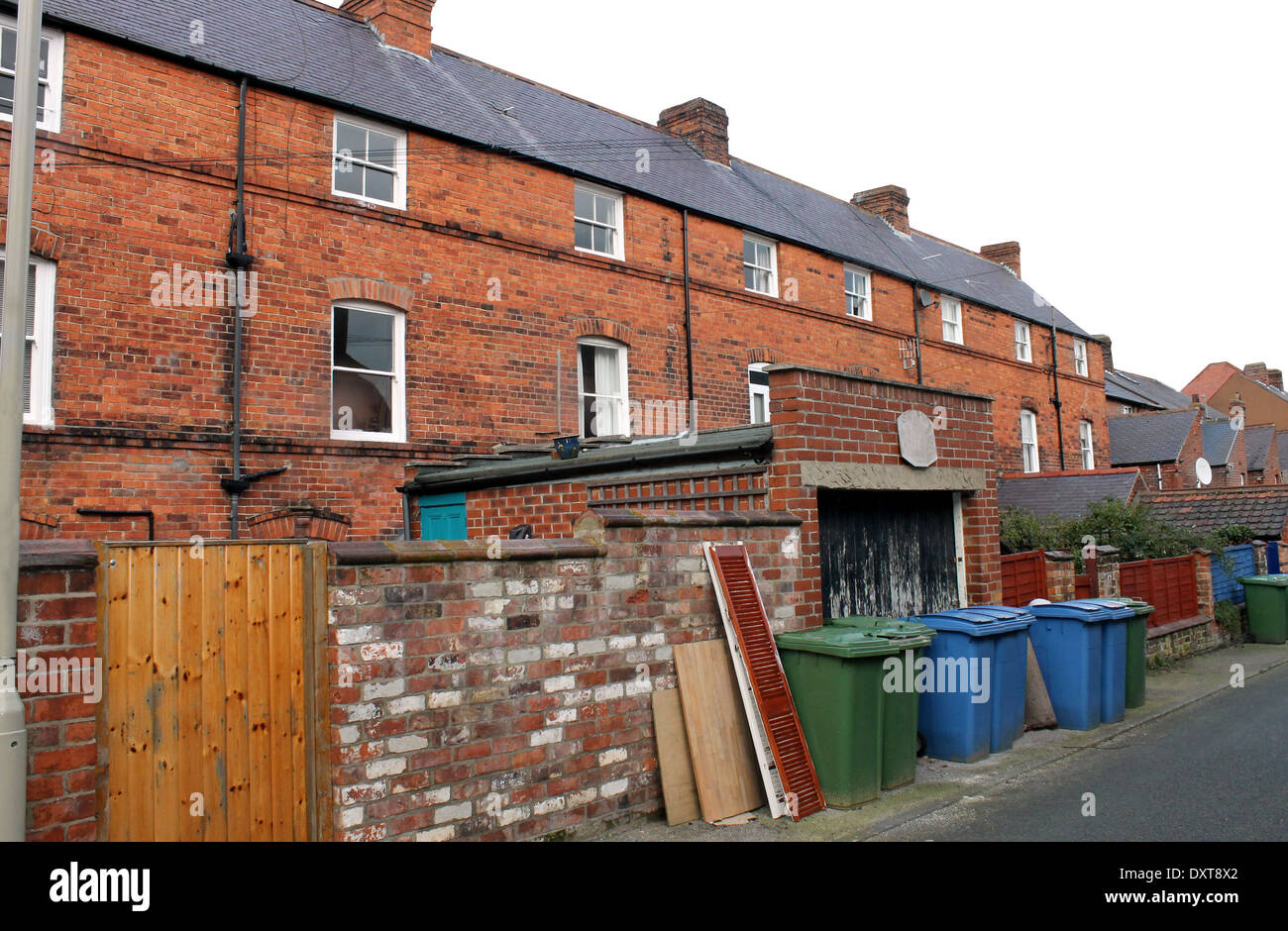 Rear view of terraced house in town with recycling bins. Stock Photo